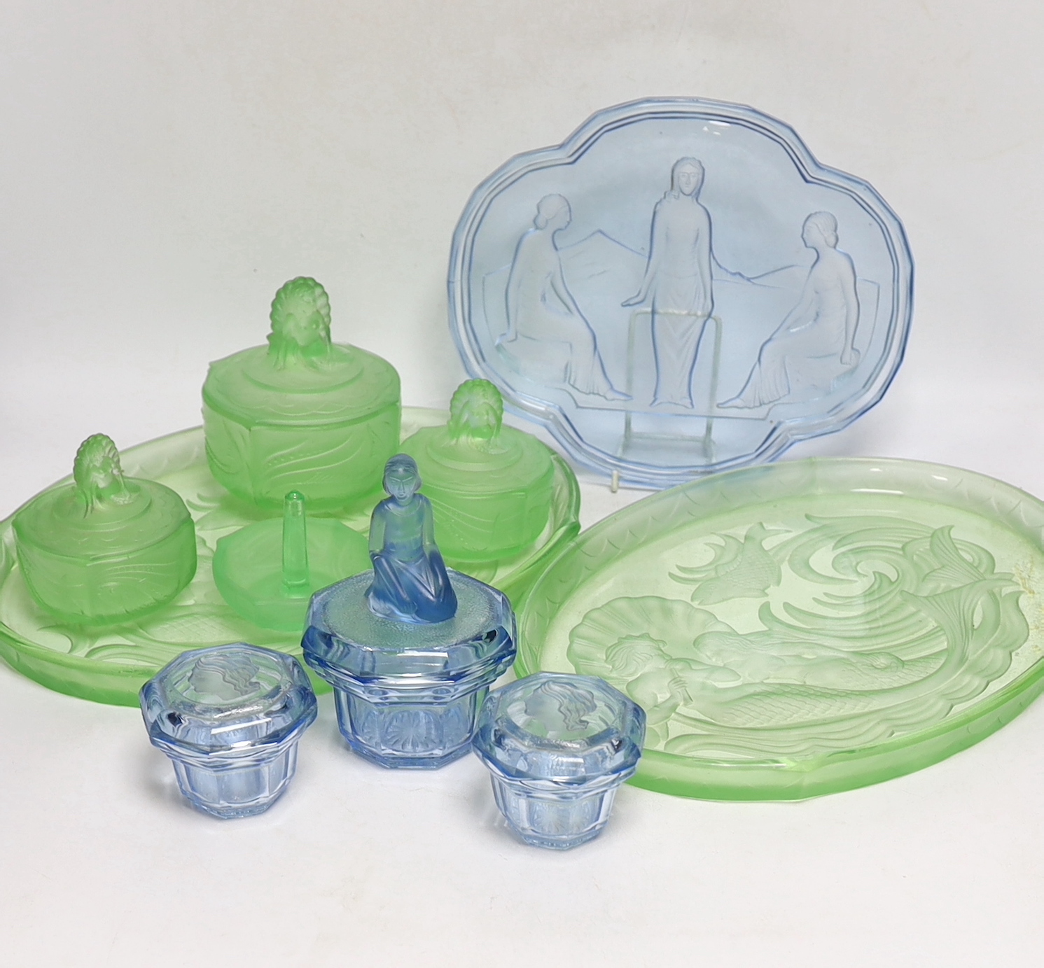 Walther & Sohne, moulded glass dressing table sets including three trays, lidded jars, etc., largest tray 35.5cm